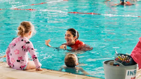 Instructor and child in pool